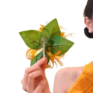 Large yellow flower hair clip with green leaves and silver metal duckbill clip