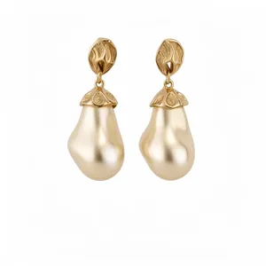 Elegant vintage drop earrings featuring elliptical cream pearls and golden textured metal finish