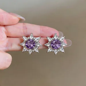 Detailed macro view of purple zirconia flower ear clips with elegant crystal petals