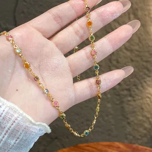 Detail view of a colorful dopamine resin bead necklace with a minimalist gold chain design.