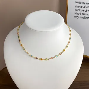 Detailed close-up view of a colorful multi-gem resin beaded gold necklace on a white bust