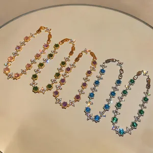 Elegant detail view of five colorful 18k gold plated flower zircon bracelets on mirror