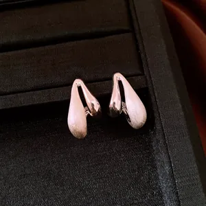 Elegant brushed metal waterdrop stud earrings displayed in a professional jewelry box