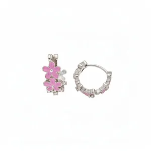 Elegant silver hoop earrings with two pink enamel flowers and shimmering crystals.