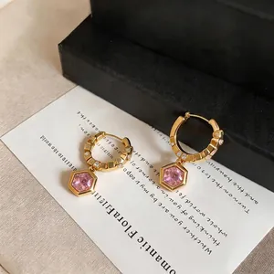 Elegant gold hoop earrings with hexagonal pink zircon pendants in French minimalist style.