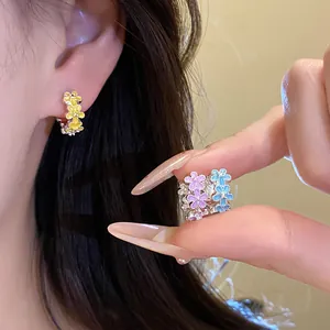 Close-up of colorful dripping oil flower ear buckles showing delicate floral details