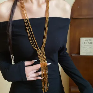 Close-up view of a retro ethnic multi-layer beaded tassel necklace on a black dress