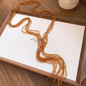 Detail shot of a vintage ethnic style multi-strand beaded necklace with amber crystal tassels