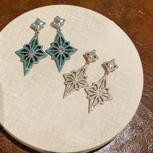 Detailed view of luxury rhombic star earrings encrusted with sparkling cubic zirconia