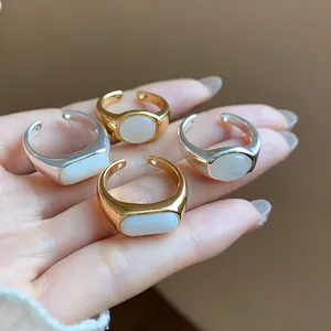 Primer plano detallado de cuatro anillos abiertos de oro de 18 quilates con resina blanca