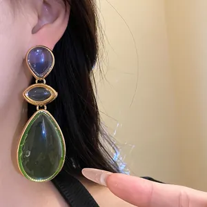 Detailed close-up showing the elegant vintage resin teardrop dangle earrings on a model