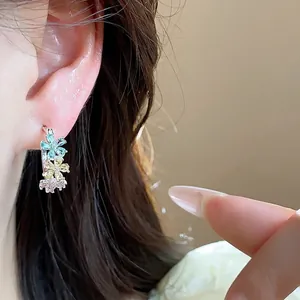 Elegant silver needle C-shaped earrings featuring multi-color zircon flowers on ear