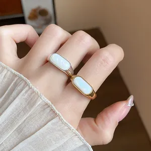 Vista detallada de anillos abiertos bañados en oro de 18k y plata con resina blanca