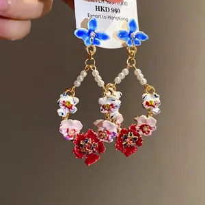 Vintage-style floral drop earrings featuring pearls and vibrant enamel flowers for a luxury look