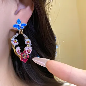 Vintage style enamel flower drop earrings featuring white pearls and silver pins
