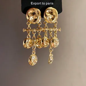 Vintage gold hammered metal drop earrings with elegant pleated pendant design for women
