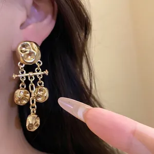 Elegant vintage gold hammered metal drop earrings featuring a unique wrinkled texture
