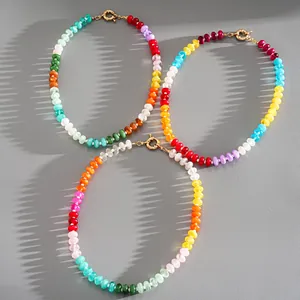 Detailed view of three colorful acrylic beaded necklaces with artistic shadows