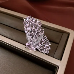 Detailed close-up of a sparkling pink crystal butterfly ring on a jewelry display tray.