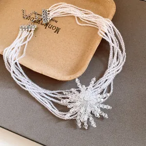 Dettaglio squisito di collana di perline di cristallo a strati con ciondolo a fiocco