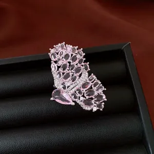 Close-up of a vintage-style butterfly ring with micro-pave pink gemstones