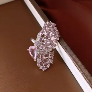 Close-up of a vintage-style butterfly ring with pink marquise and pear-cut stones.