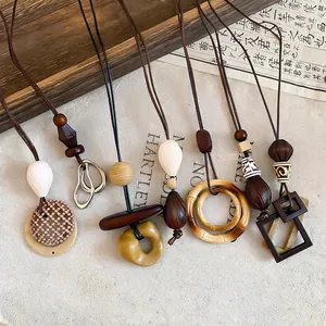 Collection of Bohemian ethnic style pendant necklaces with varied geometric designs.
