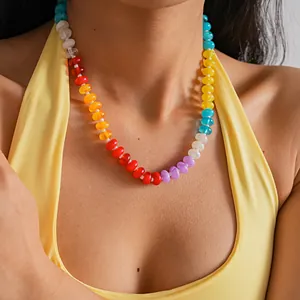Close-up of colorful acrylic beaded necklace on model in yellow top