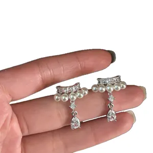 Elegant teardrop clip-on earrings featuring zircon and white pearls for non-pierced ears.
