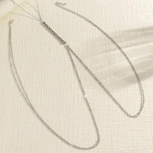 Close-up detail of a silver double-layered body chain with clear rhinestone accents.