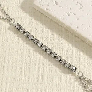 Detailed macro view of vintage double-layer body chain with sparkling clear rhinestones