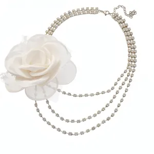Elegant multi-strand rhinestone necklace with a large white chiffon flower accent