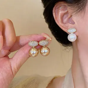 Detailed shot of elegant French zircon oval pearl drop earrings in high-end style