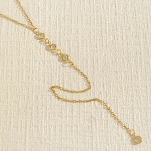 Detailed macro shot of vintage gold body chain with elegant clear beads