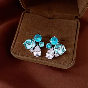 Elegant vintage silver needle earrings with blue and clear zircon clusters in a brown box