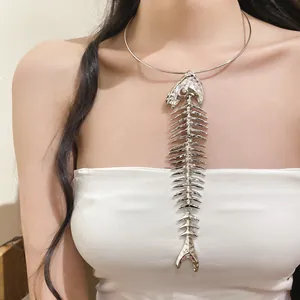 Close-up of exaggerated silver fishbone pendant choker necklace on model