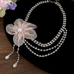 Macro shot of the delicate pink chiffon flower and sparkling rhinestone tassels