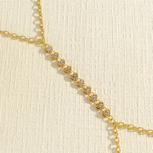 Close-up of gold double-layer body chain with sparkling rhinestones.