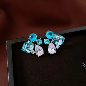 Macro view of vintage silver needle stud earrings with blue and white zircon gemstones