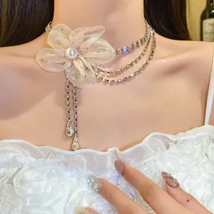 Detailed macro shot of an elegant chiffon flower choker with sparkling rhinestone tassels