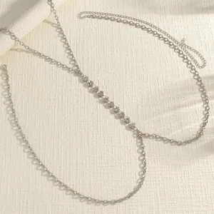 Detailed view of a silver-toned double-layered body chain featuring delicate rhinestone charms