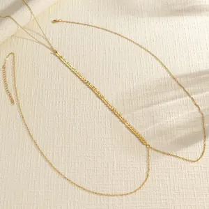 Elegant vintage gold double-layer body chain detail with herringbone pattern texture.