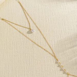 Close-up of retro double-layer gold body chain with pearl bead details