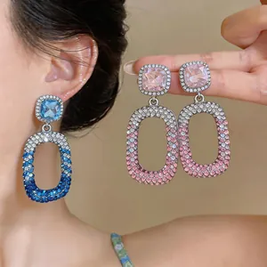 Macro view of blue and pink rhinestone drop earrings with gradient crystal pattern