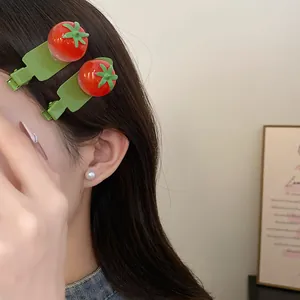 Vue détaillée de barrettes à cheveux en résine en forme de tomate sur un modèle
