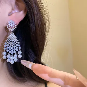Detailed macro shot of vintage French court style pearl and zircon tassel drop earrings