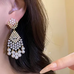 Detail of vintage French-style chandelier earrings with pearls and zirconia