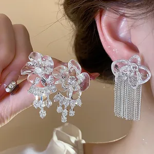 Exquisite close-up view of clear resin flower earrings with shimmering zircon and crystal tassels