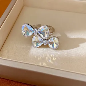 Elegant silver adjustable ring featuring double iridescent crystal butterfly bows
