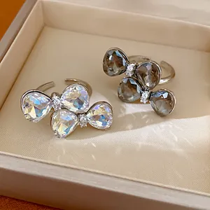 Close-up detail of rhinestone bowknot open rings with shimmering crystals in a box